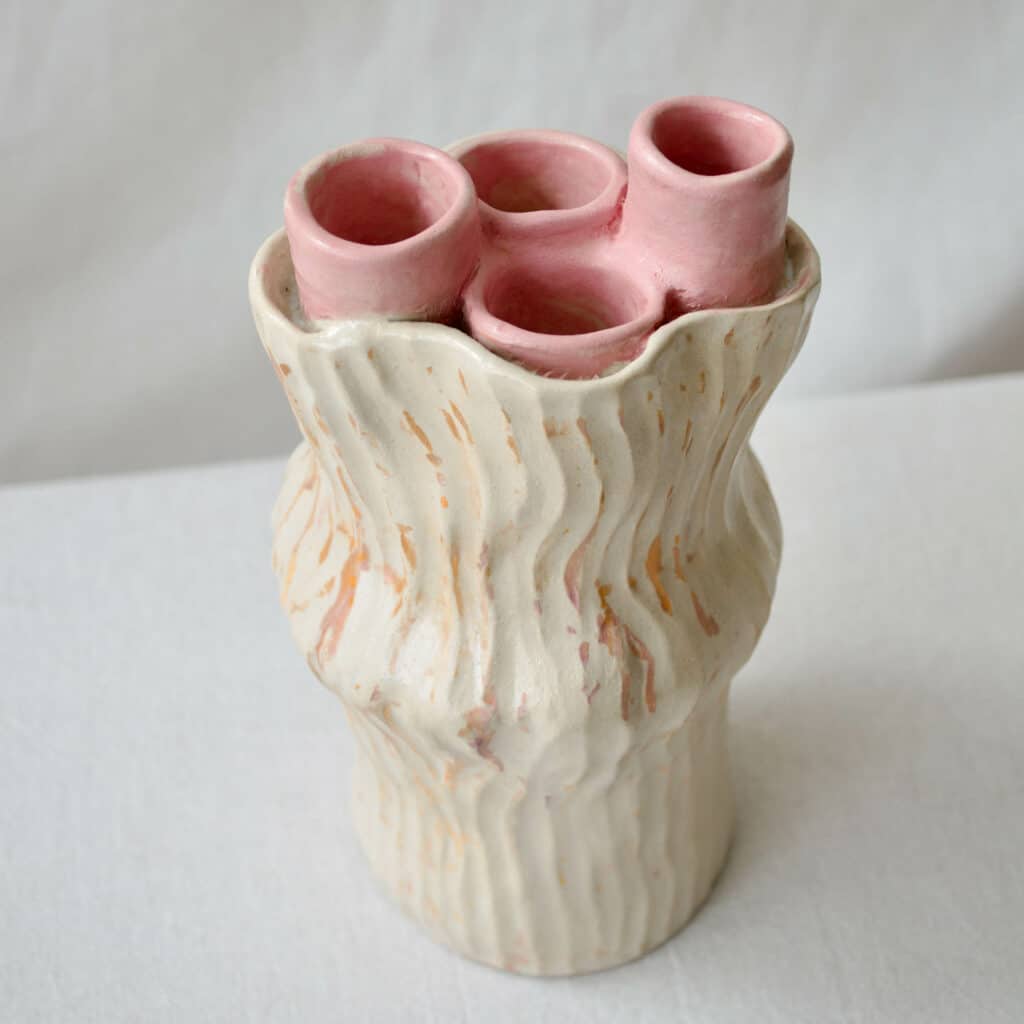 Stoneware sculpted ceramic vase inspired by sea anemone in beige and pink colours.